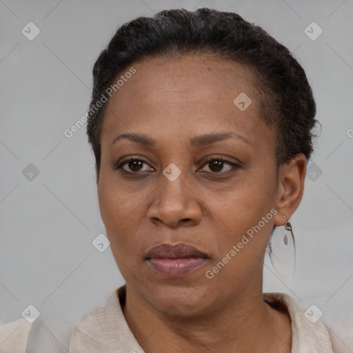 Joyful latino adult female with short  brown hair and brown eyes