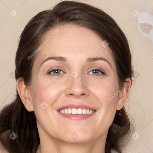 Joyful white adult female with long  brown hair and grey eyes