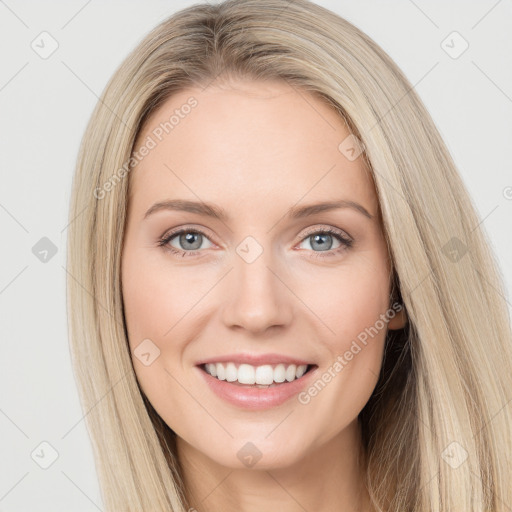 Joyful white young-adult female with long  brown hair and green eyes