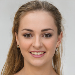 Joyful white young-adult female with long  brown hair and green eyes