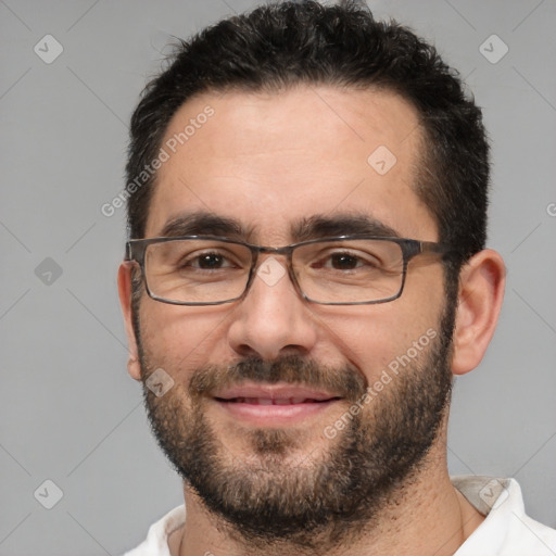 Joyful white adult male with short  black hair and brown eyes