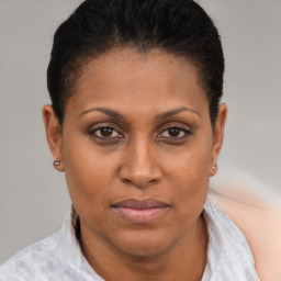 Joyful black adult female with short  brown hair and brown eyes