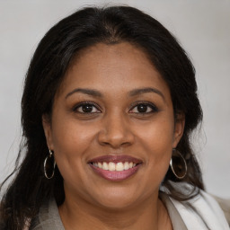 Joyful black young-adult female with medium  brown hair and brown eyes