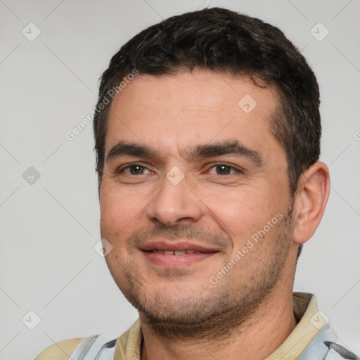 Joyful white young-adult male with short  black hair and brown eyes