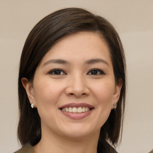 Joyful white young-adult female with medium  brown hair and brown eyes