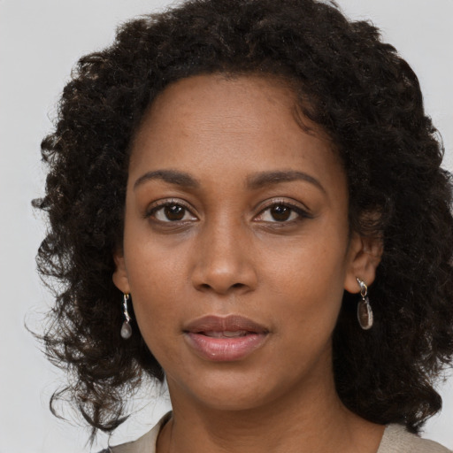 Neutral black young-adult female with medium  brown hair and brown eyes