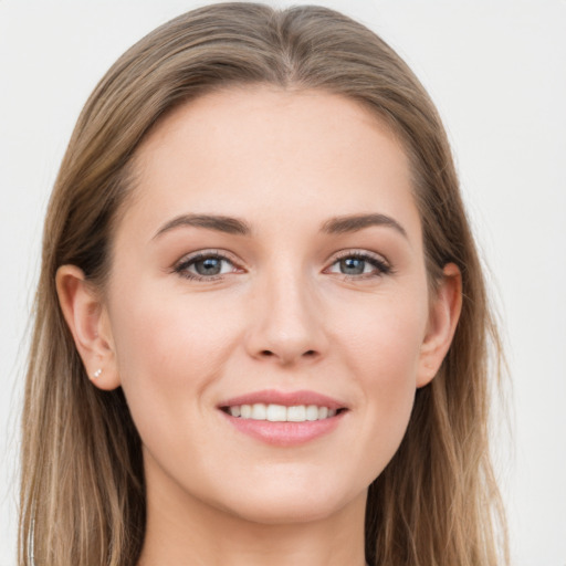 Joyful white young-adult female with long  brown hair and grey eyes