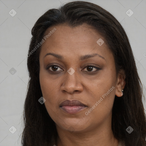 Joyful black adult female with long  brown hair and brown eyes
