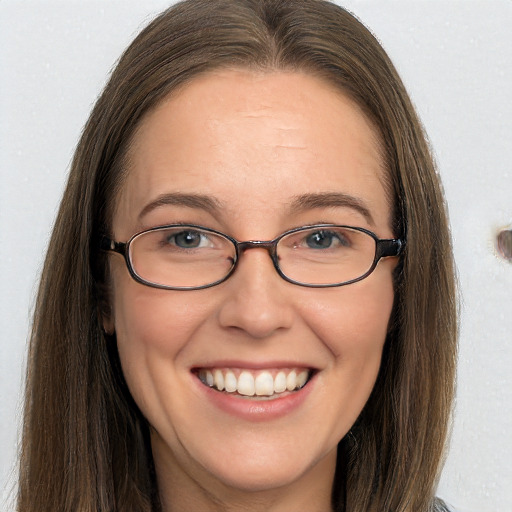 Joyful white adult female with long  brown hair and grey eyes