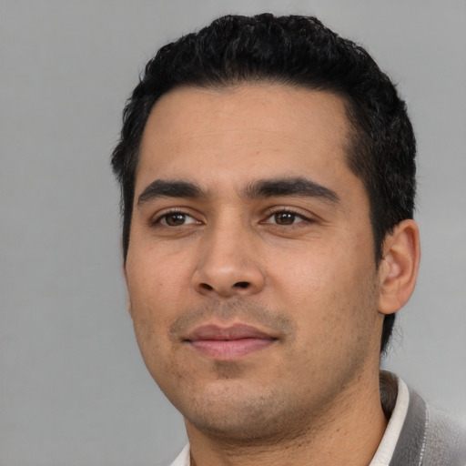 Joyful asian young-adult male with short  black hair and brown eyes