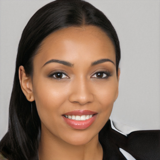 Joyful latino young-adult female with long  brown hair and brown eyes