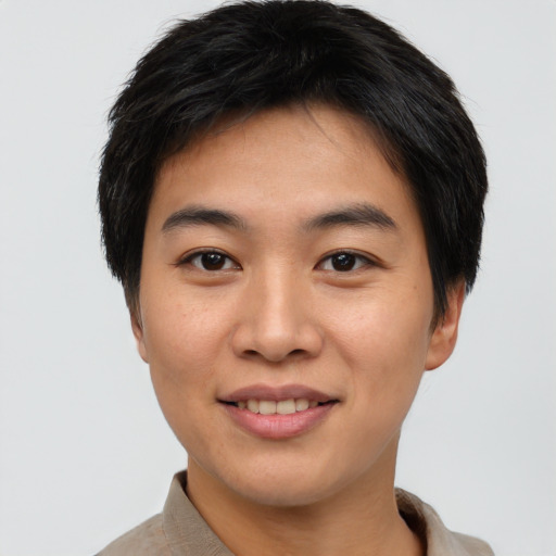 Joyful asian young-adult male with short  brown hair and brown eyes