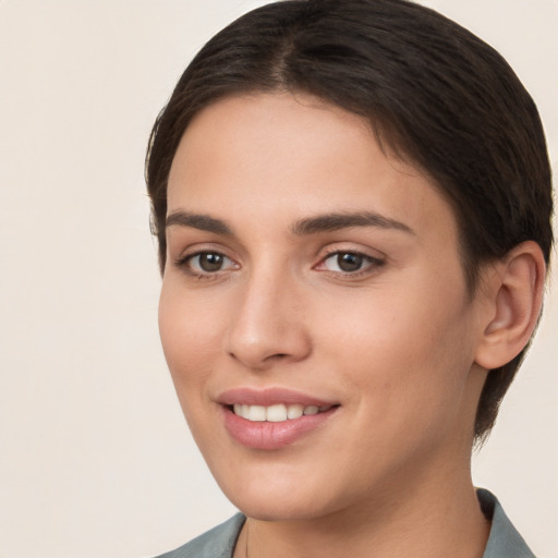 Joyful white young-adult female with short  brown hair and brown eyes