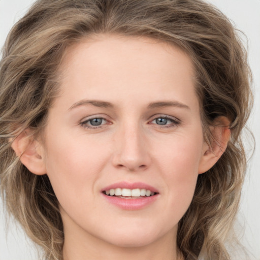 Joyful white young-adult female with long  brown hair and grey eyes