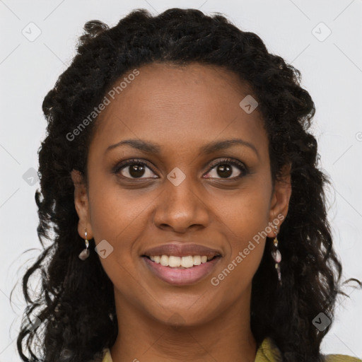 Joyful black young-adult female with long  brown hair and brown eyes