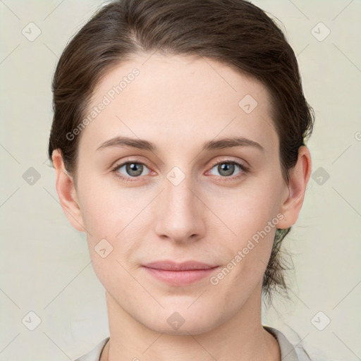 Joyful white young-adult female with medium  brown hair and grey eyes