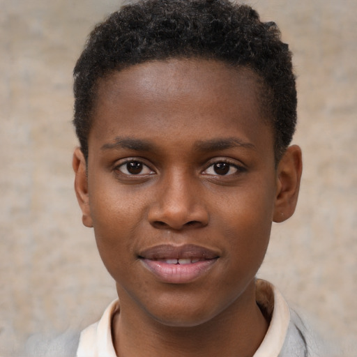 Joyful black young-adult male with short  brown hair and brown eyes