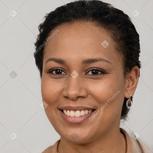 Joyful latino young-adult female with short  brown hair and brown eyes