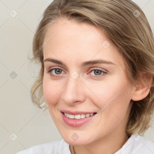 Joyful white young-adult female with medium  brown hair and blue eyes