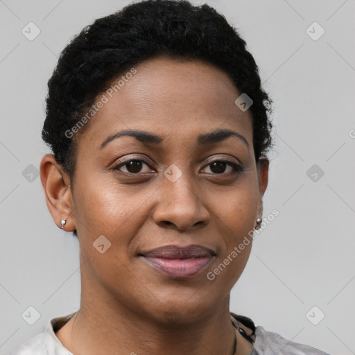 Joyful black young-adult female with short  brown hair and brown eyes