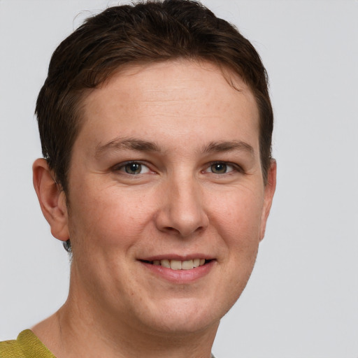 Joyful white young-adult female with short  brown hair and grey eyes