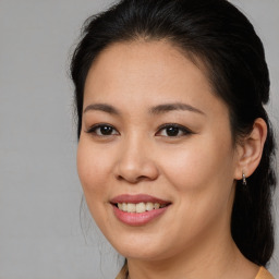 Joyful asian young-adult female with medium  brown hair and brown eyes