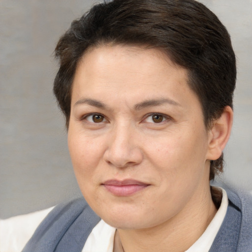 Joyful white adult female with short  brown hair and brown eyes