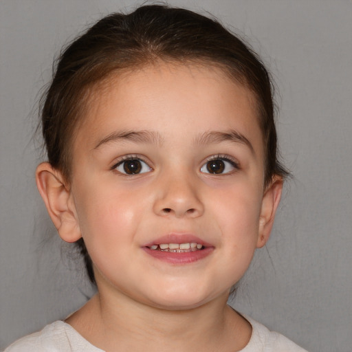 Joyful white child female with short  brown hair and brown eyes