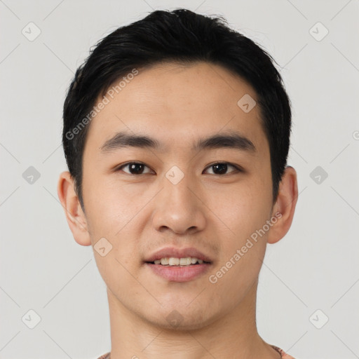 Joyful asian young-adult male with short  black hair and brown eyes