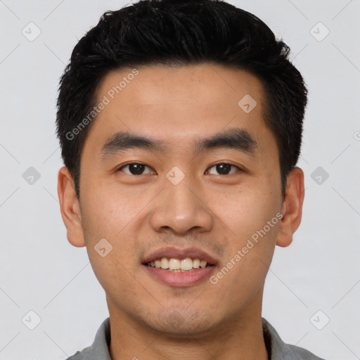 Joyful asian young-adult male with short  black hair and brown eyes