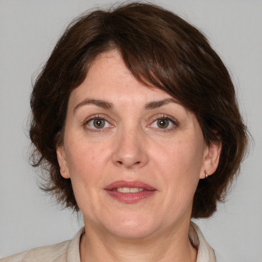 Joyful white adult female with medium  brown hair and brown eyes