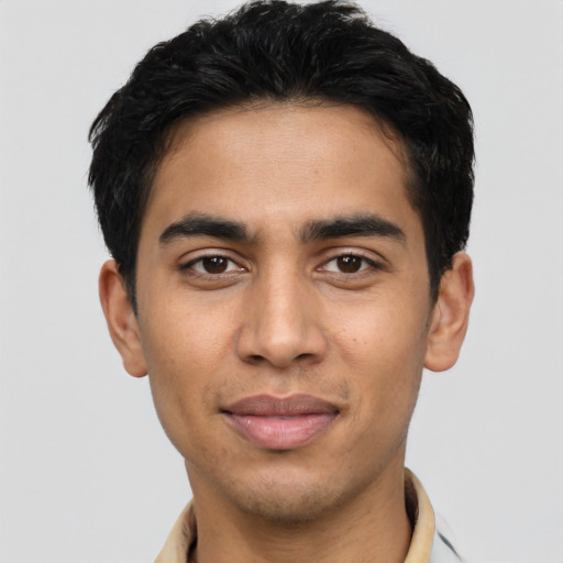 Joyful latino young-adult male with short  black hair and brown eyes