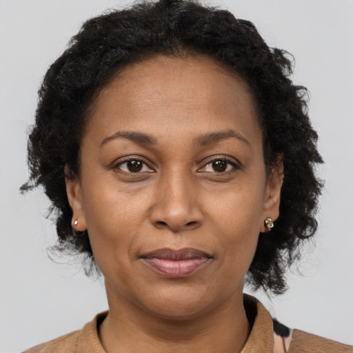 Joyful black adult female with short  brown hair and brown eyes