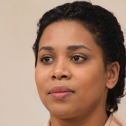 Joyful black young-adult female with medium  black hair and brown eyes