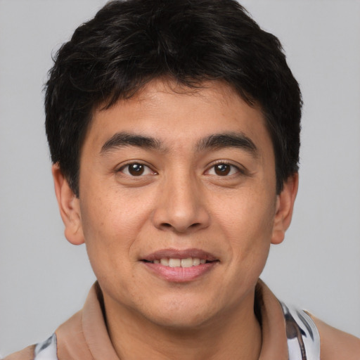 Joyful asian young-adult male with short  brown hair and brown eyes