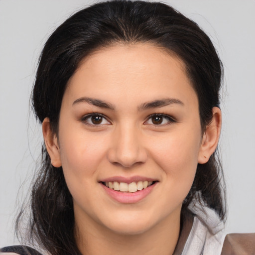 Joyful white young-adult female with medium  brown hair and brown eyes
