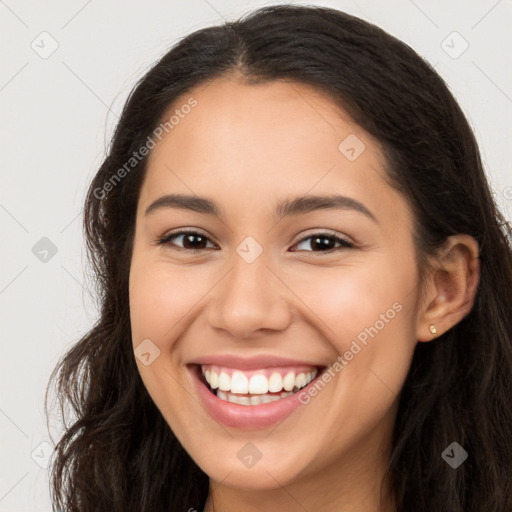 Joyful latino young-adult female with long  brown hair and brown eyes