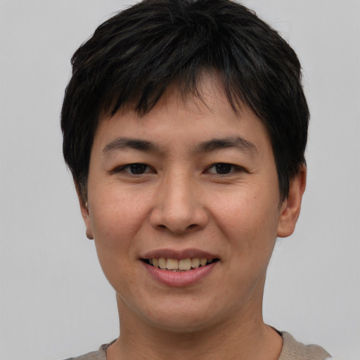 Joyful asian young-adult male with short  black hair and brown eyes