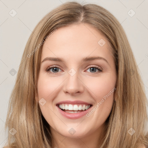 Joyful white young-adult female with long  brown hair and green eyes