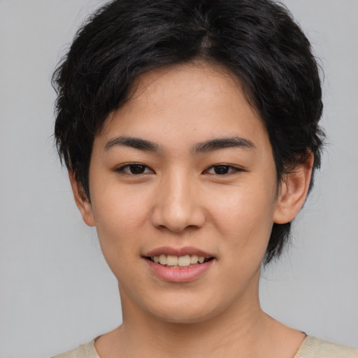 Joyful asian young-adult female with short  black hair and brown eyes