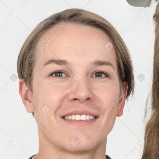 Joyful white young-adult male with short  brown hair and grey eyes