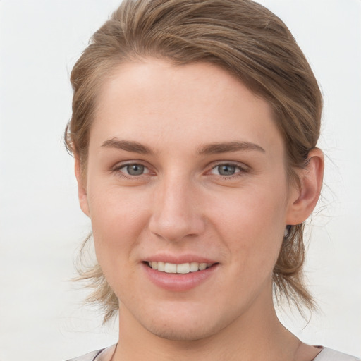 Joyful white young-adult female with medium  brown hair and grey eyes