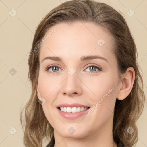 Joyful white young-adult female with medium  brown hair and grey eyes