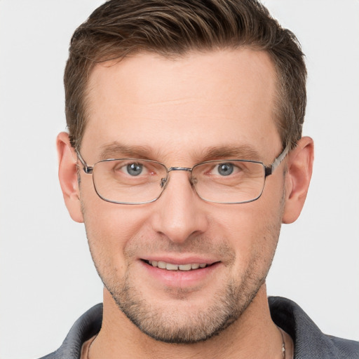 Joyful white adult male with short  brown hair and grey eyes