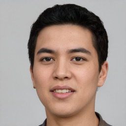 Joyful asian young-adult male with short  black hair and brown eyes