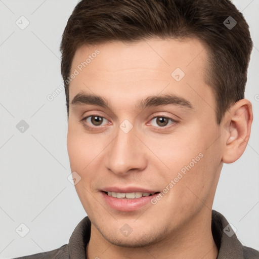 Joyful white young-adult male with short  brown hair and brown eyes