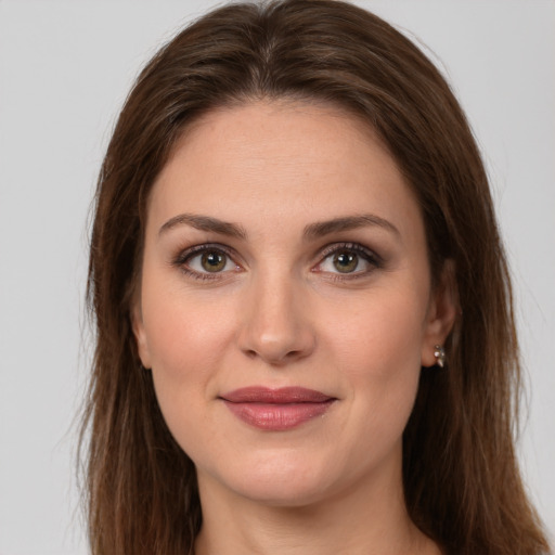 Joyful white young-adult female with long  brown hair and brown eyes