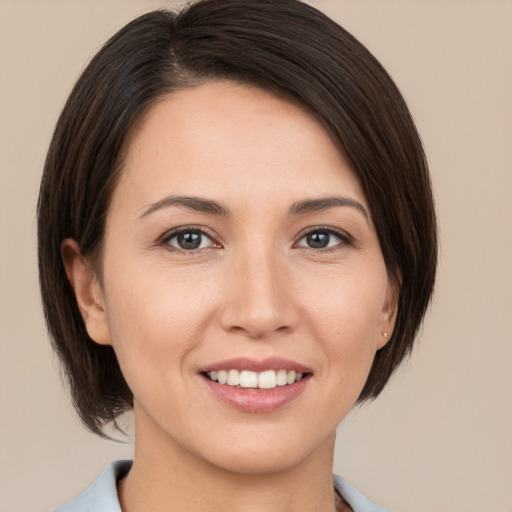 Joyful white young-adult female with medium  brown hair and brown eyes