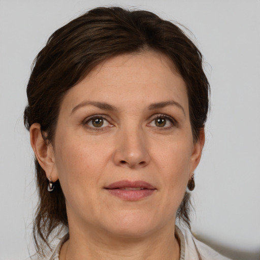 Joyful white adult female with medium  brown hair and grey eyes