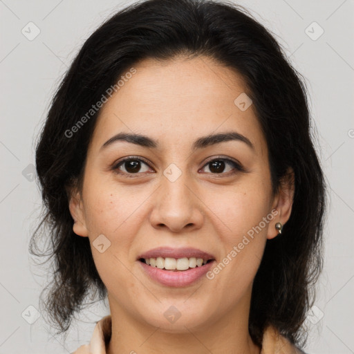 Joyful latino young-adult female with medium  brown hair and brown eyes